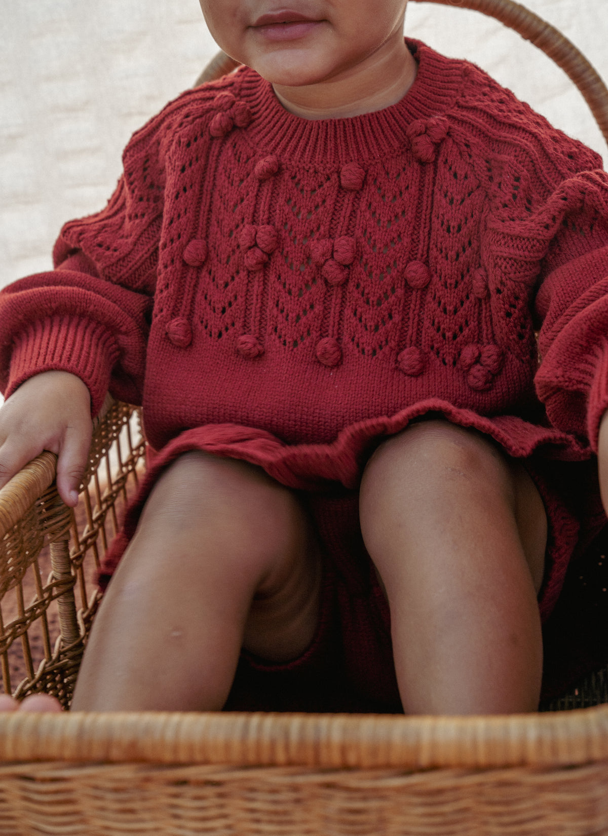 The red pom-pom knit sweater